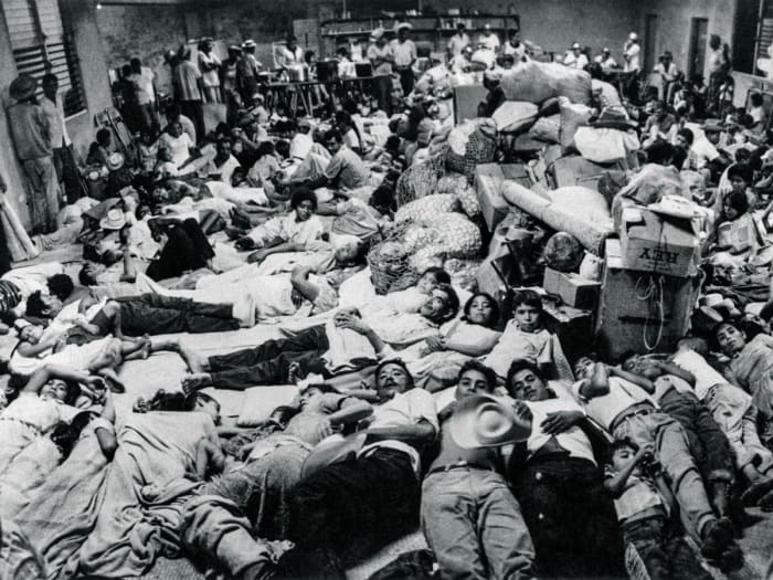 Salvadorian nationals who were residing in Honduras arrive at the Red Cross headquarters in San Miguel on July 7, 1969. Following the armed conflict between El Salvador and Honduras, 14,000 nationals residing in Honduras returned to their country.
